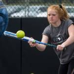 Wearing a shirt from one of her trips to Africa, Lakewood High School softball player Brittani Boortz practices bunting during Mondays practice. Boortz missed three games last month to help displaced children in Kenya for the second straight year. (Andy Bronson / The Herald)