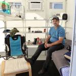 Roger Evans is working to bring a tiny home village for people experiencing homelessness to the Monroe church New Hope Fellowship. He sits in a demo unit that was brought to church grounds recently. (Lizz Giordano / The Herald)