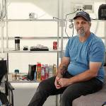 Roger Evans is working to bring a tiny home village for people experiencing homelessness to the Monroe church New Hope Fellowship. He sits in a demo unit that was brought to church grounds recently. (Lizz Giordano / The Herald)