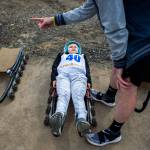 Caden Delaney squints as he is taught how to steer by USA luger Aidan Kelly during Sundays USA Luge/White Castle Slider Search program at Arrowhead Ranch on Camano Island. (Olivia Vanni / The Herald)