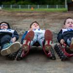 Kuper Stoner, left, Lawson Trout, center, and Reese Delaney, right, all practice their turning techniques during the USA Luge Slider Search program Sunday at Arrowhead Ranch on Camano Island. (Olivia Vanni / The Herald)
