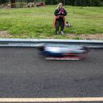 A parent takes a video as one of the lugers takes a practice run down the track during the USA Luge Slider Search program Sunday at Arrowhead Ranch on Camano Island. (Olivia Vanni / The Herald)