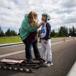 Caden Delaney gets help adjusting his helmet during the USA Luge Slider Search program Sunday at Arrowhead Ranch on Camano Island. (Olivia Vanni / The Herald)