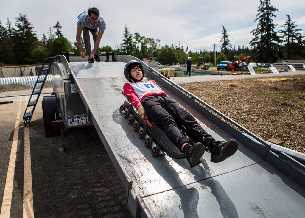 Aidan Meadows tries a track run from the ramp during the USA Luge Slider Search program Sunday at Arrowhead Ranch on Camano Island. (Olivia Vanni / The Herald)