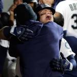 Seattle Mariners designated hitter Daniel Vogelbach (center right) hugs pitcher Felix Hernandez after Vogelbach hit a three-run home run against the Oakland Athletics during the eighth inning of a game Monday in Seattle. (AP Photo/Ted S. Warren)