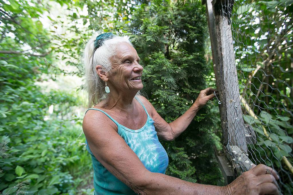 Lynn Cosmos walks into her chicken coop on her Yakima property May 13. (Amanda Ray / Yakima Herald-Republic)