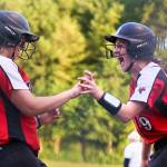 Snohomishs Sydney Sandifer (left) and Janell Williams celebrate a run against Everett during a district playoff game on May 14, 2019, at Phil Johnson Ballfields in Everett. (Kevin Clark / The Herald)