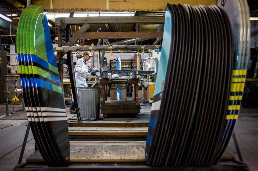 Hien Duy Do files the edge of a ski at the Connelly Skis factory in Lynnwood. (Olivia Vanni / The Herald)