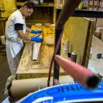 Nick Hoyt spreads resin over a water ski at Connelly Skis in Lynnwood. (Olivia Vanni / The Herald)