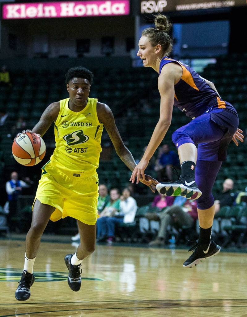 Seattles Natasha Howard dribbles around Phoenixs Stephanie Talbot during a preseason game against Phoenix on Wednesday at Angel of the Winds Arena in Everett. (Olivia Vanni / The Herald)