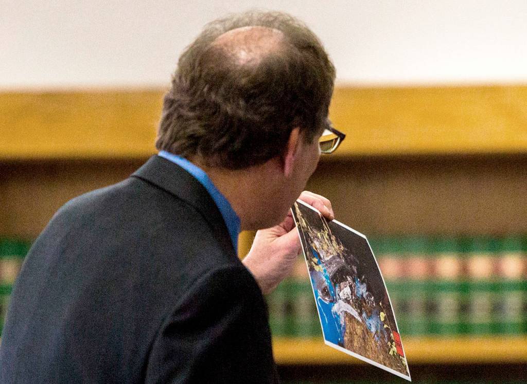 Deputy prosecutor Tobin Darrow shows the jury a photograph of Michael Spiekers totaled car during closing arguments of Spiekers trial on Thursday in Everett. (Olivia Vanni / The Herald)