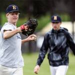 Everetts Aaron Robertson (left) makes a throw with Casen Taggart awaiting his turn during practice on May 16 at Cascade High School in Everett. (Kevin Clark / The Herald)