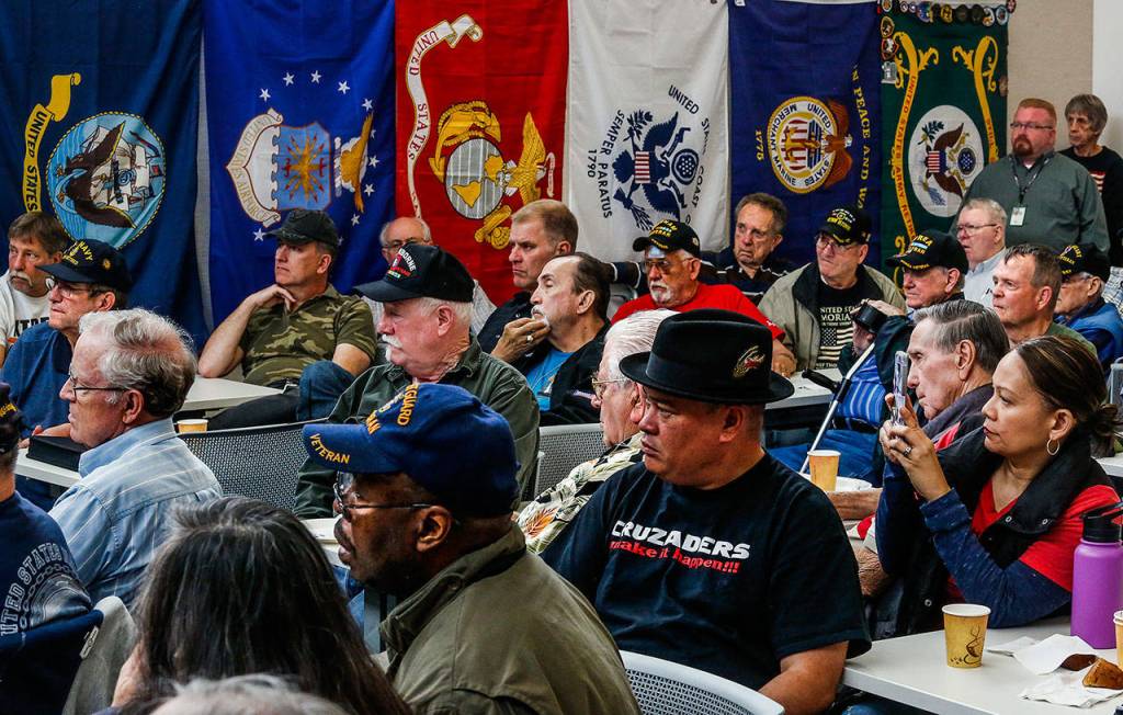 At the Heros Cafe in Lynnwood Tuesday, the packed house of more than 100 listens intently as Vietnam veteran Michael Reagan begins to talk. (Dan Bates / The Herald)