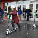 Mayor Cassie Franklin pushes off her first ride Friday morning during a launch event for an e-scooter pilot program. (Lizz Giordano / The Herald)