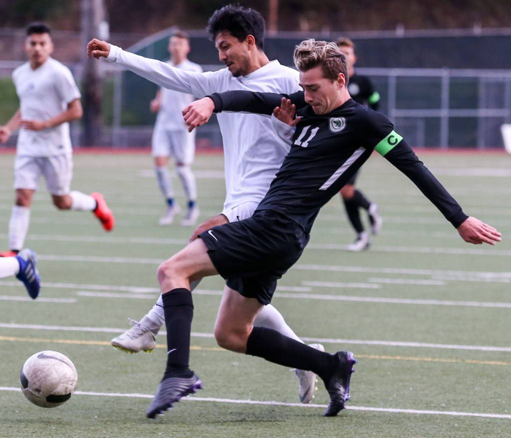 Jacksons Vincenzo DOnofrio attempts shot with Federal Ways Joel Hernandez defending during a 4A state soccer match on May 17, 2019, at Everett Memorial Stadium. The Timberwolves won 2-1. (Kevin Clark / The Herald)