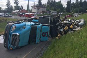 Semi tips over on Highway 99, spills 100 gallons of diesel