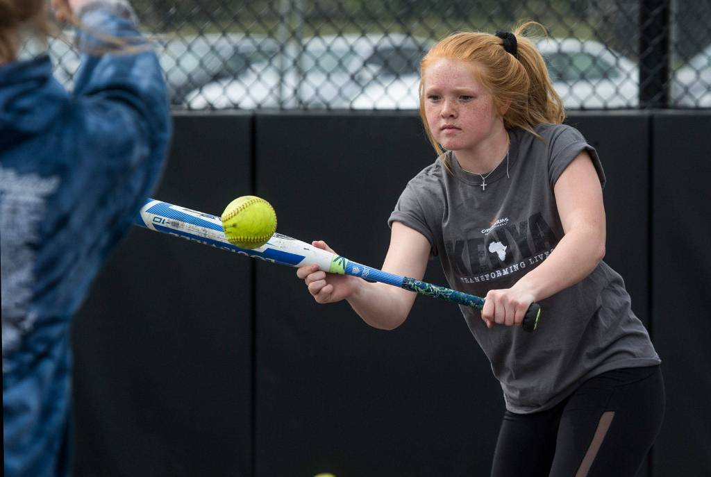 Lakewood High softball right fielder Brittani Boortz, who missed several games last month to go on a service trip to an orphanage in Kenya, practices bunting drills on May 13 in Lakewood. (Andy Bronson / The Herald)