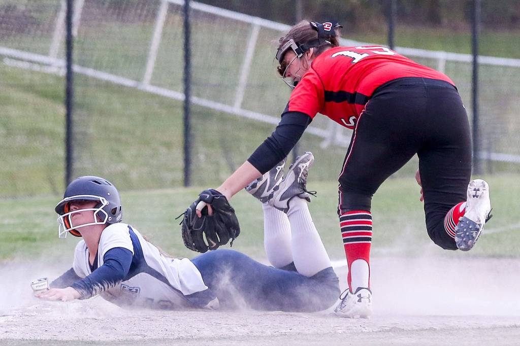 Meadowdales Kelci Studioso slides into third with Marysville Pilchucks Alissa Edge attempting a tag at Phil Johnson Fields in Everett on May 14. (Kevin Clark / The Herald)