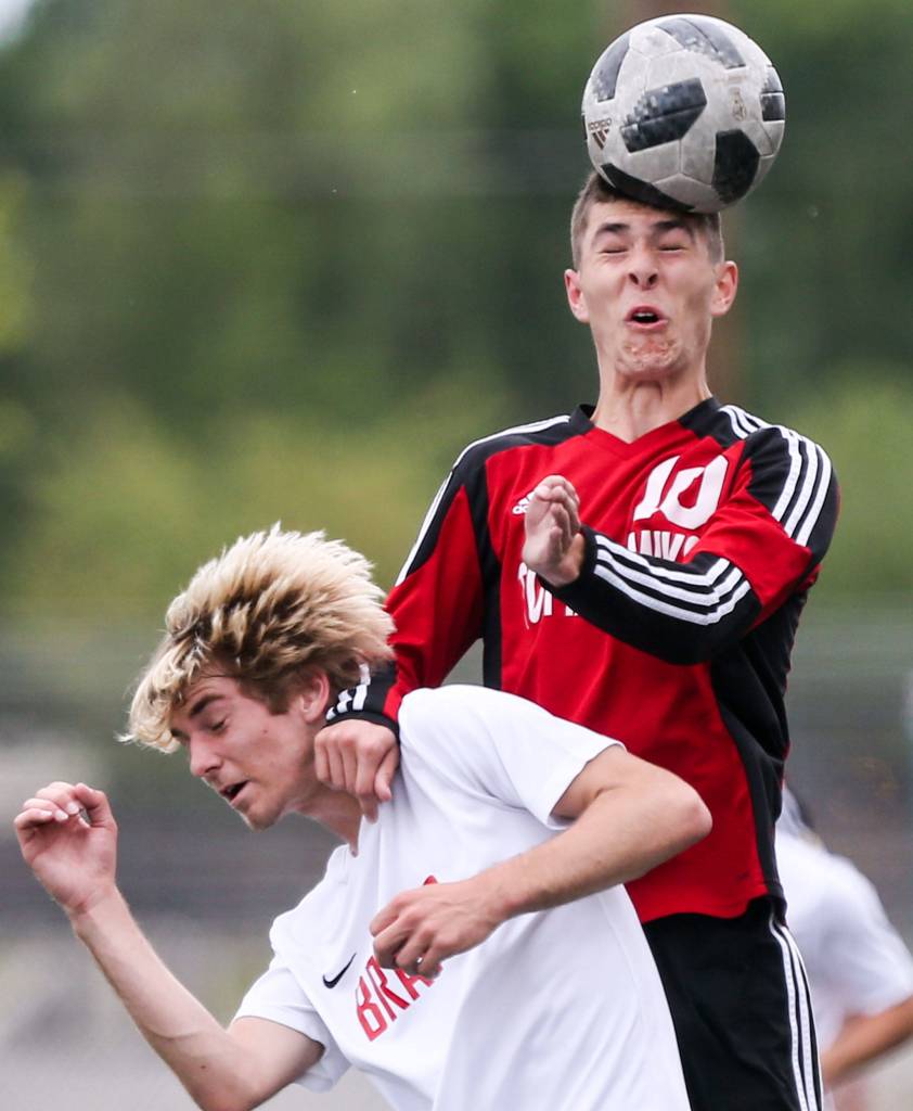 Kamiakins Garrett Grillo is blocked from a header by Marysvilles Kyle Matson at Quil Ceda Stadium in Marysville on May 14. (Kevin Clark / The Herald)