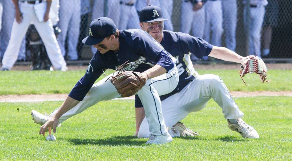 Arlingtons Camdon Anderson reaches for the ball, with pitcher Cameron Smith looking on. (Andy Bronson / The Herald)