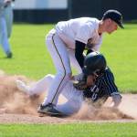 Everetts Jonathan Murphy (left) tags out Peninsulas Hunter Payne during the Seagulls 6-2 loss in a Class 3A state regional Saturday at Sherman Anderson Field in Mount Vernon. Everetts milestone-filled season ended with the defeat. (Andy Bronson / The Herald)