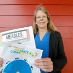 Vashon Island High School nurse Sarah Day holds information about measles vaccinations. (AP Photo/Elaine Thompson)