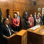 Patricia Whitefoot (center), a member of the Yakama tribe from White Swan, Washington, stands with others after after Gov. Kate Brown (left) signed a bill directing the state police to study how to improve criminal justice resources to solve cases of Native American women who have gone missing or been killed.(AP Photo/Andrew Selsky)