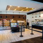 A worker yells out Fresh bread! as she brings out a tray of freshly baked goods at 85°C Bakery Cafe in Edmonds. (Olivia Vanni / The Herald)