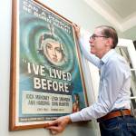 Kevin Kusinitz, a 63-year-old New Yorker who spent years being rejected from jobs for which he felt overqualified following an August 2012 layoff, straightens one of his old movie poster collection, in his apartment on New Yorks Upper East Side, Wednesday. About half of Americans think theres age discrimination in the workplace, according to a new poll by The Associated Press-NORC Center for Public Affairs Research. (AP Photo/Richard Drew)