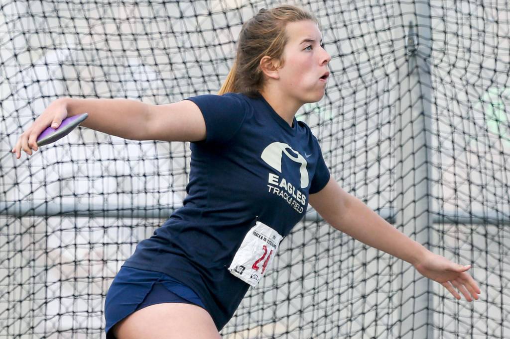 Arlingtons Julia Parra throws the discus during the first day of competition at the 4A/3A/2A State Track Field Championships on Thursday at Mount Tahoma High School in Tacoma. (Kevin Clark / The Herald)