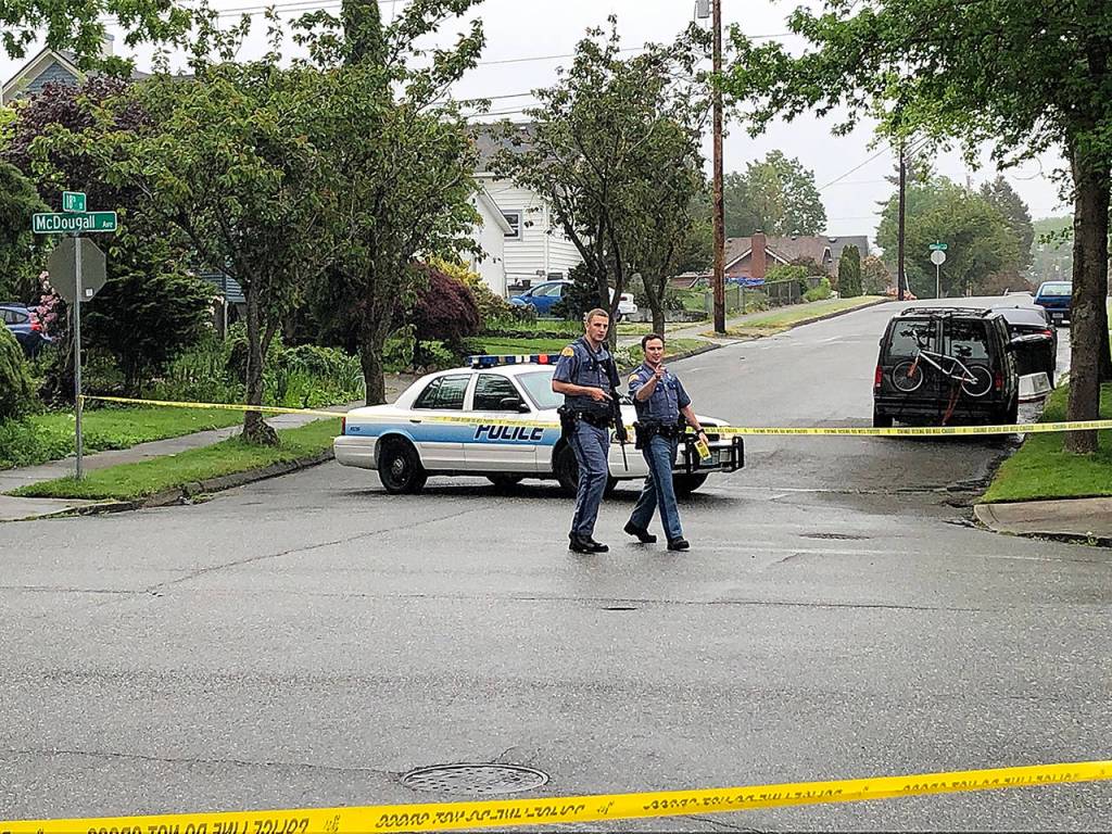 Everett police secure an area in the 1700 block of McDougall Avenue in Everett on Friday morning. (Caleb Hutton / The Herald)