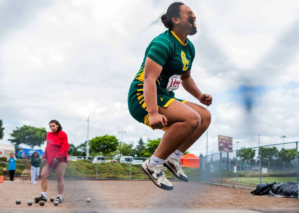 Kiana Lino jumps in the air in celebration after throwing the shot put a personal best and winning distance of 44 feet, 10 inches during the second day of competition at the 4A/3A/2A State Track Field Championships on Friday at Mount Tahoma High School in Tacoma. (Olivia Vanni / The Herald)