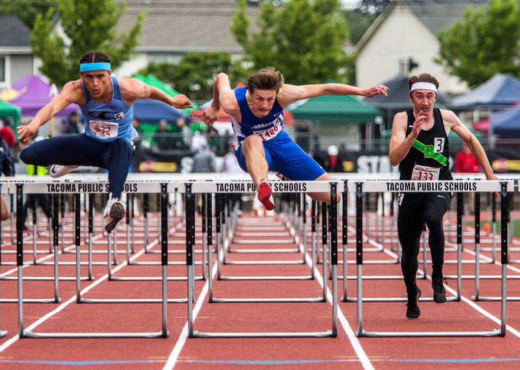 Shorewoods Jonathan Birchman (center) jumps over the last hurdle in the 3A Boys 110 meter hurdles during the second day of competition at the 4A/3A/2A State Track Field Championships at Mount Tahoma High School in Tacoma, Wash. (Olivia Vanni / The Herald)