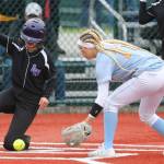 Lake Washingtons Emma Rosendal scores as Everetts Jackie Rookaird (right) tries to make a play Friday morning during the 3A Softball State Championships at the Regional Athletic Complex in Lacey. (Kevin Clark / The Herald)