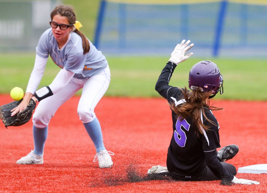 Lake Washingtons Addie Sapirstein slides into second base as Everetts Annie Fowler bobbles the throw Friday morning during the 3A Softball State Championship at the Regional Athletic Complex in Lacey. (Kevin Clark / The Herald)