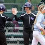 Lake Washington celebrates a run off of Everetts Jackie Rookaird (right) Friday morning during the 3A Softball State Championship at the Regional Athletic Complex in Lacey. (Kevin Clark / The Herald)