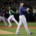 The Mariners Connor Sadzeck (right) watches as the Athletics Stephen Piscotty rounds the bases after hitting a home run during the eighth inning of a game on May 24, 2019, in Oakland, Calif. (AP Photo/Ben Margot)