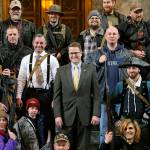 In this 2015 photo, Washington Rep. Matt Shea, R-Spokane Valley (center), poses for a group photo with gun owners inside the Capitol in Olympia, following a gun-rights rally. Recently published internet chats from 2017 show Shea and three other men discussing confronting leftists with a variety of tactics, including violence, surveillance and intimidation. (AP Photo/Ted S. Warren, File)