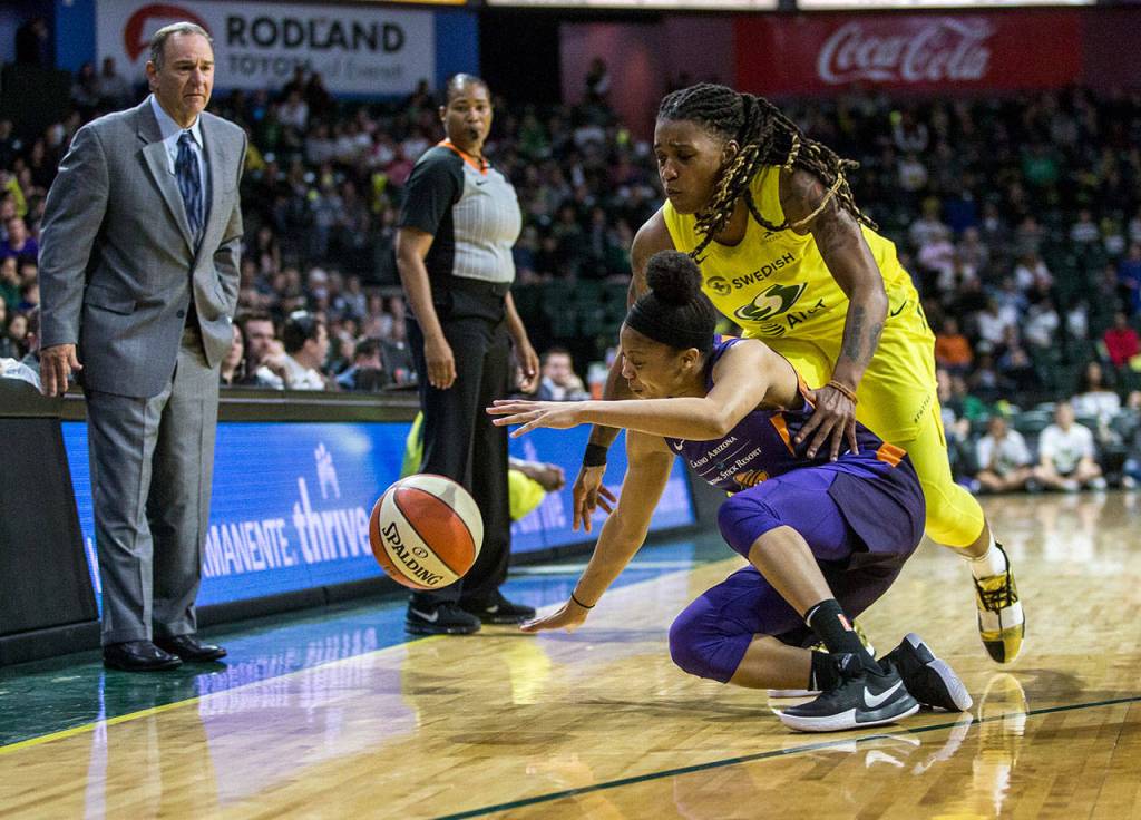 Seattle Storms Shavonte Zellous scrambles for the ball with Phoenix Mercurys Arica Carter during the season opener game against the Phoenix Mercury on Saturday, May 25, 2019 in Everett, Wash. (Olivia Vanni / The Herald)