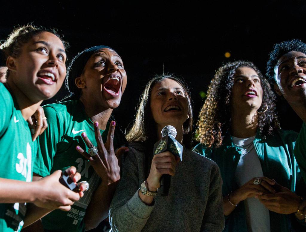 Seattle Storms Kaleena Mosqueda-Lewis, Crystal Langhorne, Sue Bird, Alysha Clark, and Natasha Howard react to their championship banner being revealed during the ring ceremony before the season opener game against the Phoenix Mercury on Saturday, May 25, 2019 in Everett, Wash. (Olivia Vanni / The Herald)