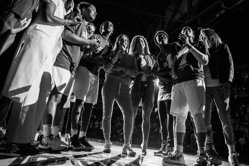 The Seattle Storm gather on the court for their championship banner unveiling before the start of the season opener game against the Phoenix Mercury on Saturday, May 25, 2019 in Everett, Wash. (Olivia Vanni / The Herald)
