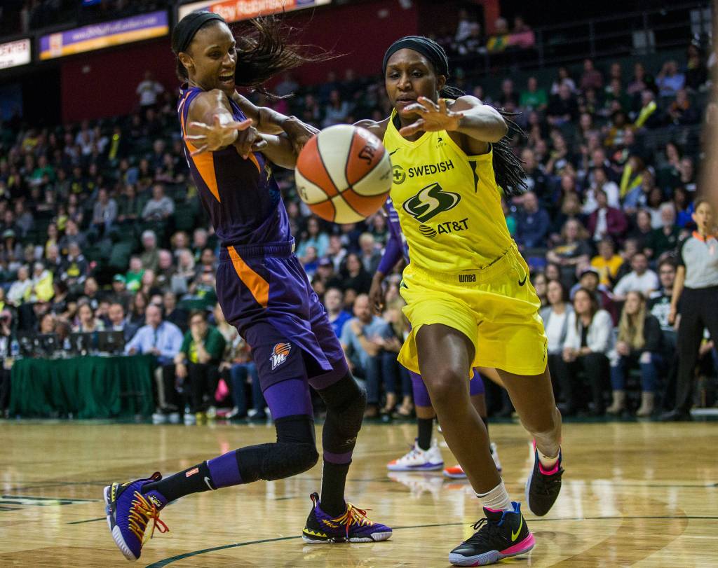 Seattle Storms Crystal Langhorne scrambles after the ball with Phoenix Mercurys DeWanna Bonner resulting in a foul during the season opener game against the Phoenix Mercury on Saturday, May 25, 2019 in Everett, Wash. (Olivia Vanni / The Herald)
