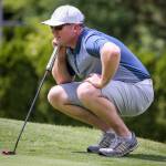 Jacob Rohde lines up a putt Sunday afternoon during the second round of the Snohomish County Amateur golf tournament at Harbour Pointe Golf Club in Mukilteo. Rohde shot a 2-under-par 70 to take a one-shot lead going into Mondays final round. (Kevin Clark / The Herald)