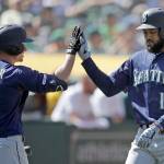 Seattles Domingo Santana (right) is congratulated by Kyle Seager (15) after hitting a home run off Oaklands Blake Treinen on Saturday in Oakland, California. (AP Photo/Ben Margot)