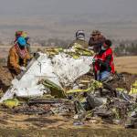 In this March 11 photo, rescuers work at the scene of an Ethiopian Airlines flight crash near Bishoftu, Ethiopia. Pilot Bernd Kai von Hoesslin pleaded with his bosses for more training on the Boeing Max, just weeks before the Ethiopian Airlines jet crashed, killing everyone on board. (AP Photo/Mulugeta Ayene, File)