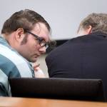 Dakota Reed consults with his attorney before he is sentenced to a year in jail at Snohomish County Courthouse on Tuesday in Everett. Reed had pleaded guilty in May to two counts of threats to bomb or injure property and spewing violent speech on fake Facebook pages for months. (Andy Bronson / The Herald)