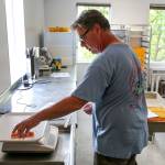 Scott Albrecht test samples at the labs of NSF International in Everett. (Kevin Clark / The Herald)