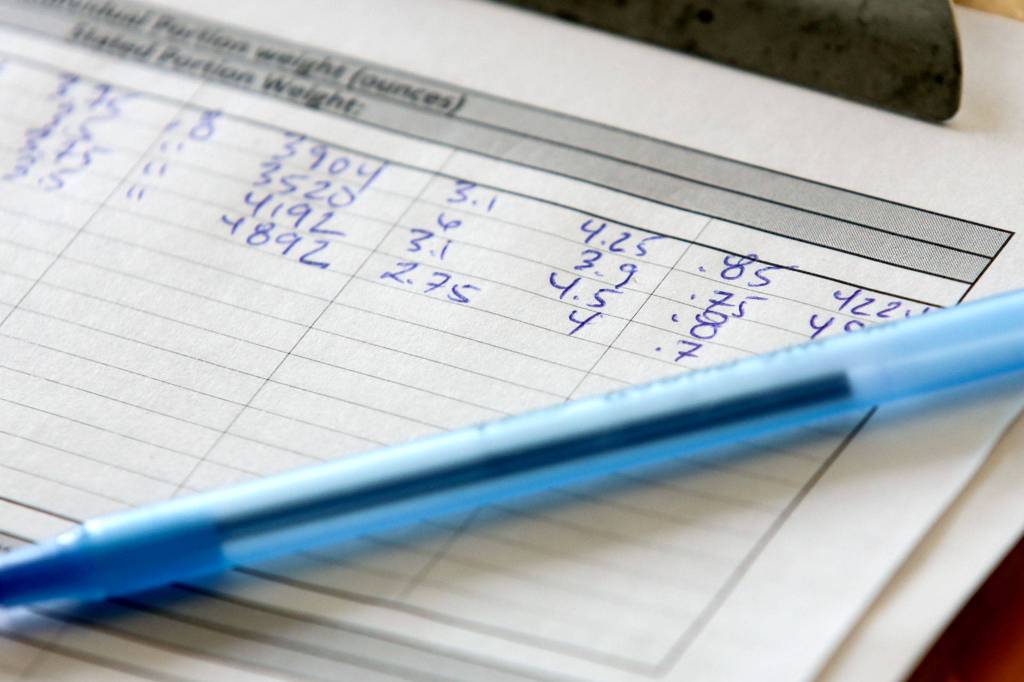 Measurements are recorded from salmon samples at the labs of NSF International in Everett. (Kevin Clark / The Herald)