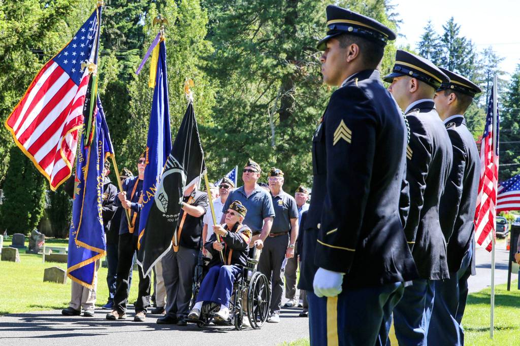 Members of American Legion Post #66 and VFW #8870 present the Colors during the 37th Annual Memorial Day Ceremony at the Edmonds Memorial Cemetery and Columbarium in Edmonds on May 27. (Kevin Clark / The Herald)