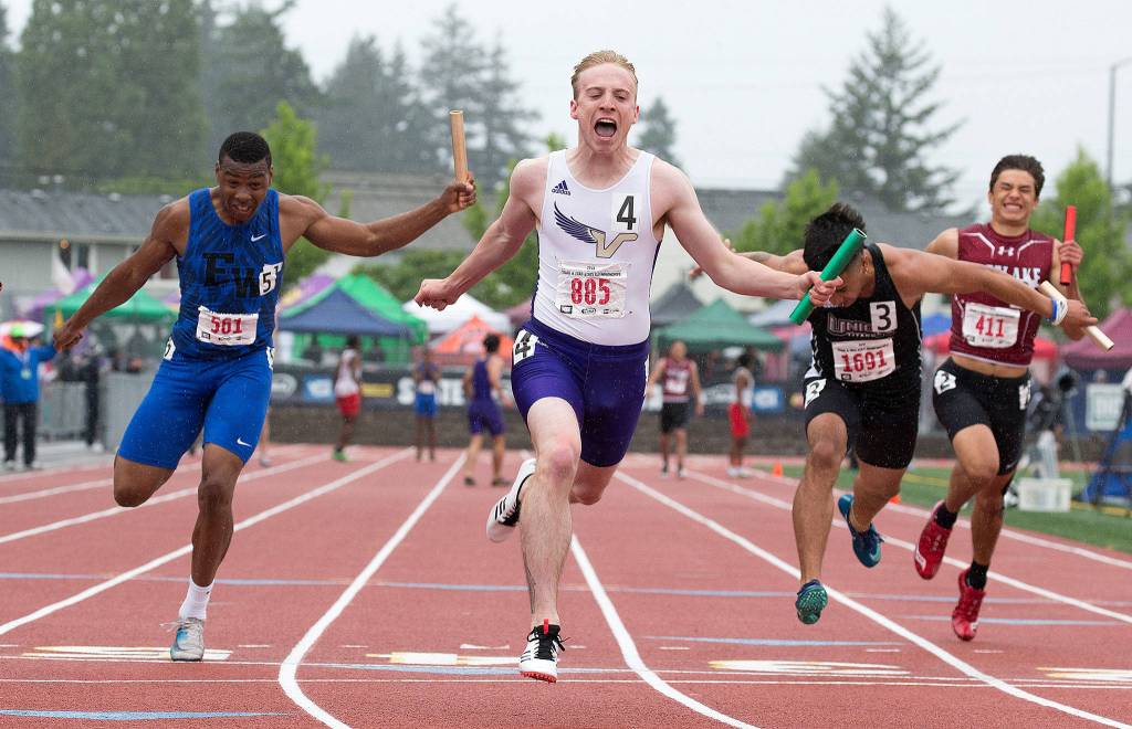 Lake Stevens Matthew Zehrung cheers as he crosses the finish line to give the Vikings state a title in the Boys 4x100 meter relay at Mount Tahoma Stadium on May 25 in Tacoma. (Andy Bronson / The Herald)